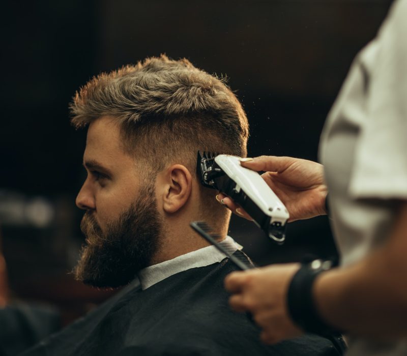 young-bearded-man-getting-haircut-by-hairdresser-6.jpg